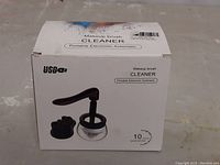 Box front showing the makeup brush cleaner with handle, container, and brush holder attachments. Claim of 10 second quick automatic cleaning cycle.