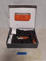 Open box showing pair of black insulated boots inside with packaging