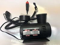 Photo of a black 250 PSI air compressor with attached power cord and inflating pins.
