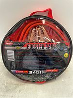 Front of round black zippered storage bag with clear panel showing coiled red booster cables and copper clamps inside. Label shows brand CM Auto, 12 ft length, 8 gauge, usable up to -45C.