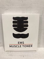 Front view of EMS Muscle Toner packaging showing black abdominal and arm muscle stimulator pads illustration