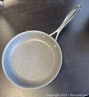 Top view of 8-inch gray speckled Granitium nonstick coated frying pan with metal handle, showing the interior cooking surface and handle design.