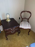 Wide angle showing the chair, side table, and Master Quartz Clock together in corner of a room
