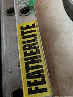 Close-up of yellow FeatherLite logo on the ladder