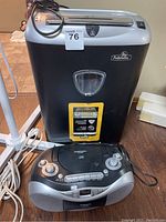 Photo showing Fellowes paper shredder and Digital Lab disc boombox on floor