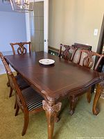 Table and chairs arranged in room showing full set