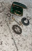 Jewelry lot layout showing assorted vintage handmade jewelry including the dragon pendant, necklace, pins, ring, and bracelet in a green lined jewelers box.