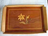 Wooden tray with floral inlay, medium wood with flower and leaf design, has handles on sides