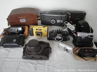 Group shot of all cameras and cases on table