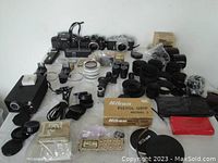 Overview of all camera bodies and Nikon branded accessories arranged on table