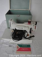 Singer Featherweight 221K sewing machine on base with power cord, foot pedal, spool and manual