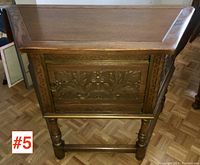 Front view showing carved relief door and original varnish finish on solid oak server
