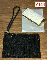 Photo showing both black and white vintage beaded evening bags together on a wooden surface.