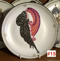 Full view of the plate showing the front art deco style figure design with black and purple flowing garments.