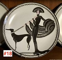Full view of porcelain plate featuring Art Deco woman and dog design, rim border visible.