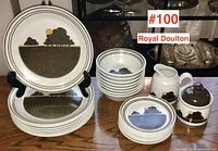 Full view of stacked dinner plates, bowls, side plates, creamer and sugar pot showing the set's design and quantity.