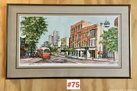 Full view of framed hand signed print featuring a Toronto Queen West street scene with streetcar and buildings.