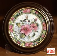 Full view of the Royal Doulton decorative plate in brown round frame with floral and hummingbird design