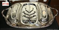 Top view of the vintage silver plated meat platter displaying ornate handles, decorative edges, and two covered side servers in place on the tray.
