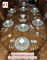Full table set for eight showing place settings with plates, cups, saucers, and silverware partially visible.