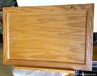 Top view of the vintage wooden folding desktop showing wood grain and framed edges.