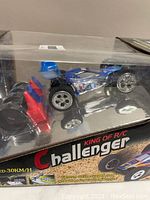 Front view of King of R/C Challenger remote control car in sealed packaging showing car and remote control.