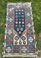 Full view of the hand woven wool rug showing overall pattern and border colors.