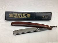 Dovo BlackStar Solingen straight edge razor with wooden handle and original black case with gold lettering.