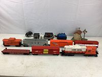 Full view of all six train cars arranged in two rows, visible colors and labels including Illinois Central engine, caboose, mail railway boxcar, and flatbed.