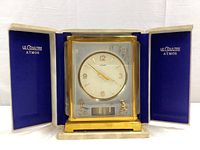 Clock displayed in open original fitted box with blue velvet lining