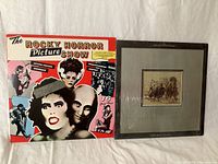Two vinyl records shown front covers: The Rocky Horror Picture Show soundtrack colorful cover featuring stylized character faces; the other has sepia-tone image, possibly a classical or world music album by Stanley Thomas Burleigh.