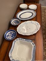 Photo showing full view of all items laid out on table including platters, plates, and bowls in blue and white patterning.
