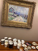Assortment of ceramic mugs in white, black and with patterns arranged on a wooden table.