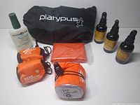 All items arranged with Platypus black bag, 3 bottles J.Crow's Lugol's Solution, 2 orange bug head nets, bug spray, emergency bivy, and blanket.