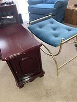 Photo showing the wooden side table with storage compartment door and the brass frame bench with velour seat in room setting.
