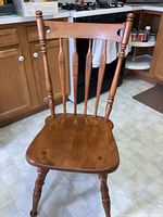 Ethan Allen colonial wooden chair showing front seat and backrest with turned legs and spindles.