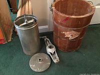 Full lot of vintage ice cream maker parts including wooden barrel, metal inner container, lid, and crank handle