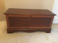 Front view of Lane cedar chest showing lock keyhole and decorative wood panel on front.