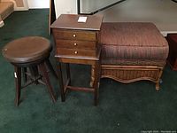 Photo showing all three items: jewelry stand with three drawers, piano stool, and wicker ottoman with cushion on green carpet