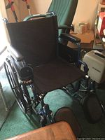 Drive brand manual wheelchair with black nylon seat, footrests, and metal frame