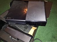 Xbox One console with Kinect sensor and power cord visible in open box.