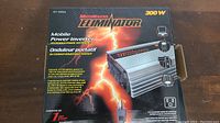 Image of MotoMaster Eliminator 300 W Mobile Power Inverter box with product image and branding visible