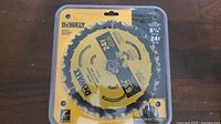 Front view of the DeWalt 8 1/4" saw blade in sealed packaging, showing brand, size, and tooth count