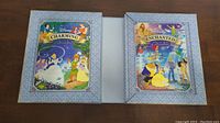 Two Disney Magical Tales books: Charming Tales and Enchanted Tales with colorful covers showing classic Disney characters.
