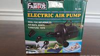 Box of the World Famous Electric Air Pump No. 303 showing product name, usage for inflatables such as air mats, boats, furniture, and toys.