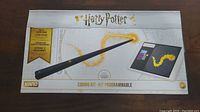 Front view of the Harry Potter Kano coding kit box showing the wand and a tablet interface, branding and key features.