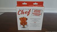 Front view of Master Chef chicken roaster box showing branding, product type and item dimensions.