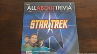 Front of the boxed Star Trek trivia game showing title, series characters, and branding