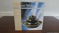 Box showing Circean Steps brand and product image of the tabletop relaxation fountain