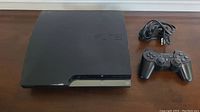Sony PS3 console angled top view showing PS3 logo and overall shape